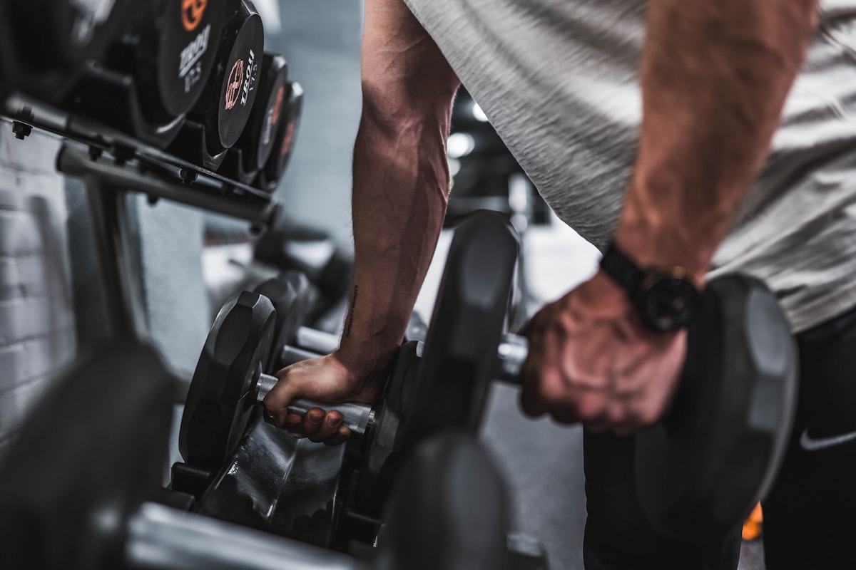 Athlete pressing dumbbells
